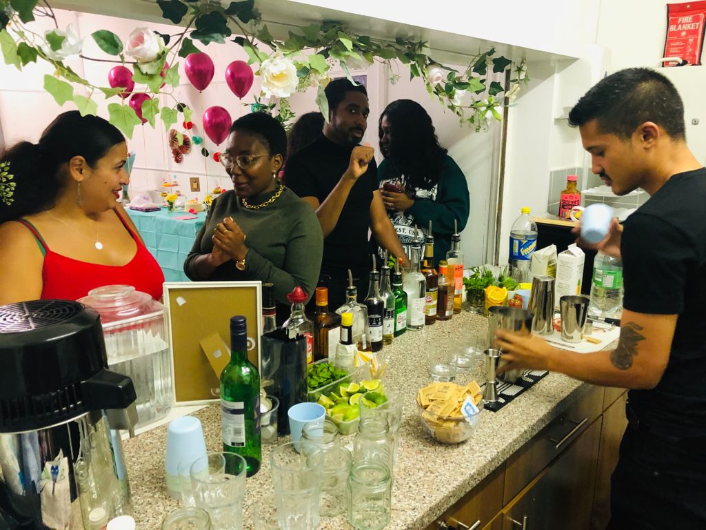 Adults enjoying an event around the social counter at Deronda Hall