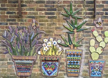 Completed mosaic planters in the garden at Deronda Hall