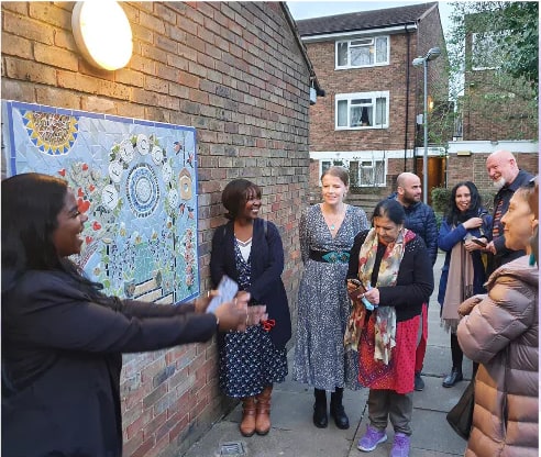 Adult community partners unveiling the garden mosaic at Deronda Hall